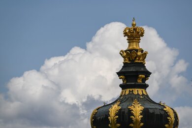 Wolken ziehen hinter dem Kronentor des Dresdner Zwingers am Himmel auf.