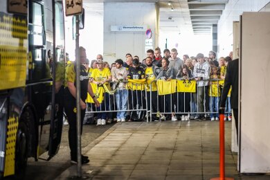 BVB-Fans warten am Flughafen Dortmund am Mannschaftsbus.