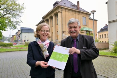 Regina Kraushaar, die Präsidentin der Landesdirektion Sachsen, hat OB Heinrich Kohl den Fördermittelbescheid für die Sanierung des Clemens-Winkler-Clubs (im Hintergrund) in Aue übergeben.