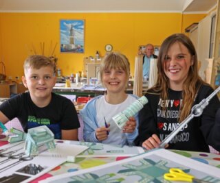 Der zehnjährige Tim Brauer, die neunjährige Denise Emily Geißler und die zwölfjährige Larissa Urbschad aus Torgau (Foto von links) haben in der Schauwerkstatt der Miniwelt Lichtenstein Modelle von weltweit bekannten Bauwerken aus Papier gebastelt. 