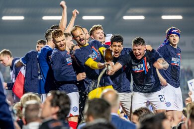 Die Spieler von Kiel feiern mit den Fans gemeinsam den Aufstieg.