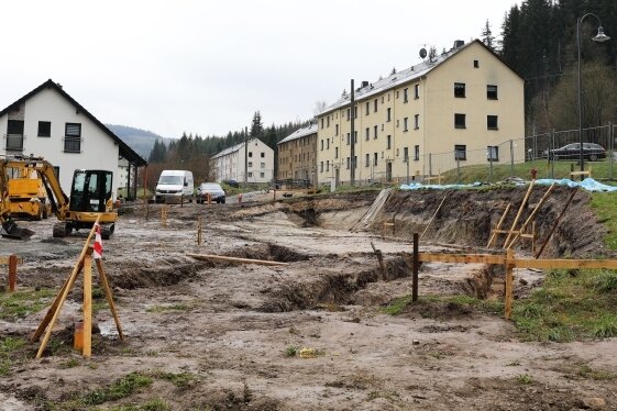 Abriss und Neubau in Milchbachsiedlung - Ein im Mai 2021 entstandenes Bild mit Symbolcharakter: Rechts drei der alten Wohnhäuser der Milchbachsiedlung Erlabrunn, links ein neues Eigenheim und im Vordergrund die Fläche für ein weiteres Eigenheim. 