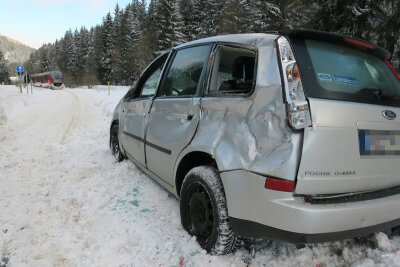 Auto steckt am Bahnübergang fest - Kollision mit Zug - Der Ford war am Montagmorgen in einem Schneehaufen am Bahnübergang stecken geblieben.