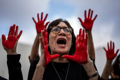 Bilder des Tages vom 07.04.2024 - Familienangehörige und Unterstützer der im Gazastreifen festgehaltenen Geiseln demonstrieren in Tel Aviv mit roter Farbe an den Händen, die Blut symbolisieren soll.