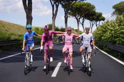 Bilder des Tages vom 26.05.2024 - Sportsgeist im Viererpack: Gesamtführender Tadej Pogacar (im rosafarbenen Trikot) fährt Arm in Arm mit Giulio Pellizzari, Jonathan Milan und Antonio Tiberi auf der letzten Etappe des Giro d'Italia.