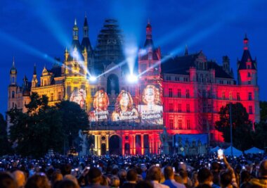 Bilder des Tages vom 29.06.2024 - Zuschauer beobachten die Licht- und Laserinszenierungen "Sound of Germany", die erstmals im Rahmen des Schlossfests in Schwerin gezeigt wird.