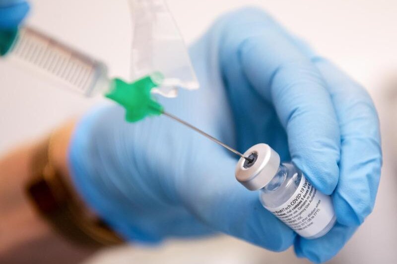            Eine Klinik-Mitarbeiterin zieht den Covid-19 Impfstoff von Biontech/Pfizer für eine Impfung auf eine Spritze.