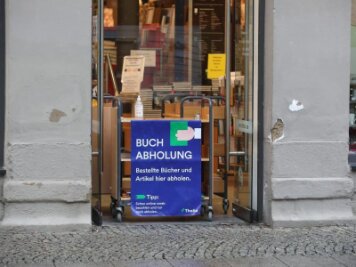 Corona-Lage in Chemnitz: Stadt lockert Beschränkungen - «Buchabholung» steht auf einer Tafel an einer Buchhandlung.