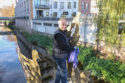 Peter Kallfels säubert sein Kunstwerk "Angler" in der Chemnitzer Innenstadt.