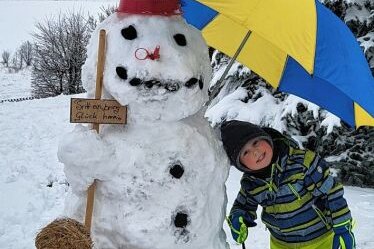 Der Besuchermagnet - Der vierjährige Leon hat gemeinsam mit seiner Mutter Peggy und seiner Großmutter Katrin Gläßer einen Schneemann in deren Garten in der Neuhausener Straße in Seiffen gebaut.