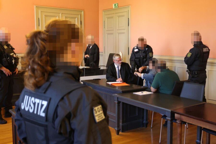 Der „Ehrenmord“ von Crimmitschau: Ehefrau mit elf Messerstichen getötet - Am Montag im Gerichtssaal. Ein Beamter nimmt dem Angeklagten die Handschellen ab.