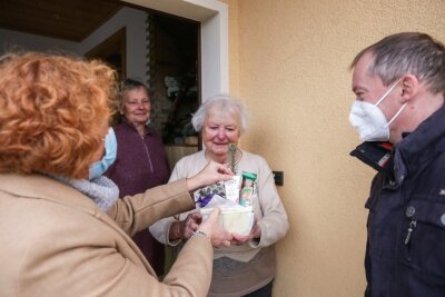 Ein Adventskorb für Frau Donat - Gemeinderäte auf Geschenketour: Claudia Elsner und Dirk Kärgling überreichen Hanna Donat ein Geschenkkörbchen. 