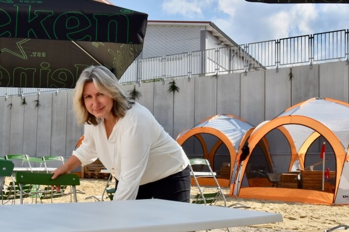 Inhaberin Mandy Hartig stellt in der neuen "Citylounge" an der Weststraße in Limbach-Oberfrohna Gartenstühle auf. In den nächsten Wochen werden ausschließlich die Plätze im Freien zum Entspannen und Feiern zur Verfügung stehen.