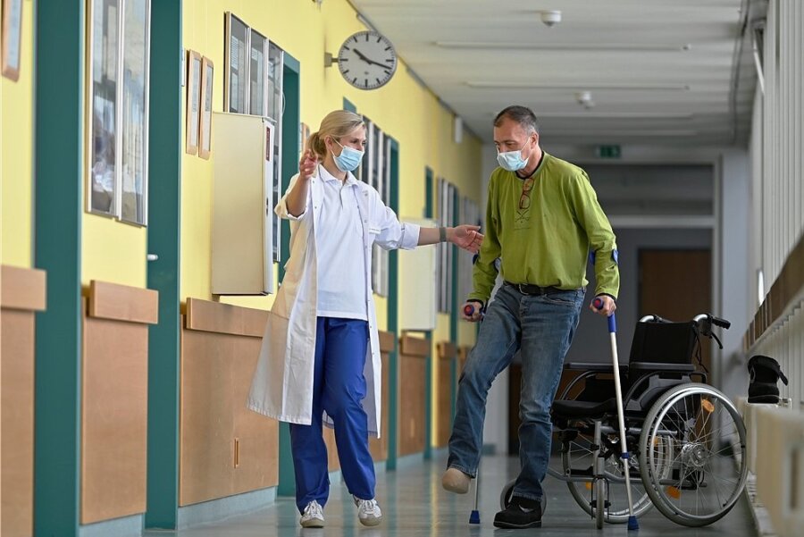 Dr. Elisabeth Wendt vom Diabetischen Fußzentrum der Helios Weißeritztal-Klinik Freital unterstützt den Dresdner Patienten bei seinen ersten Gehversuchen ohne Rollstuhl. 