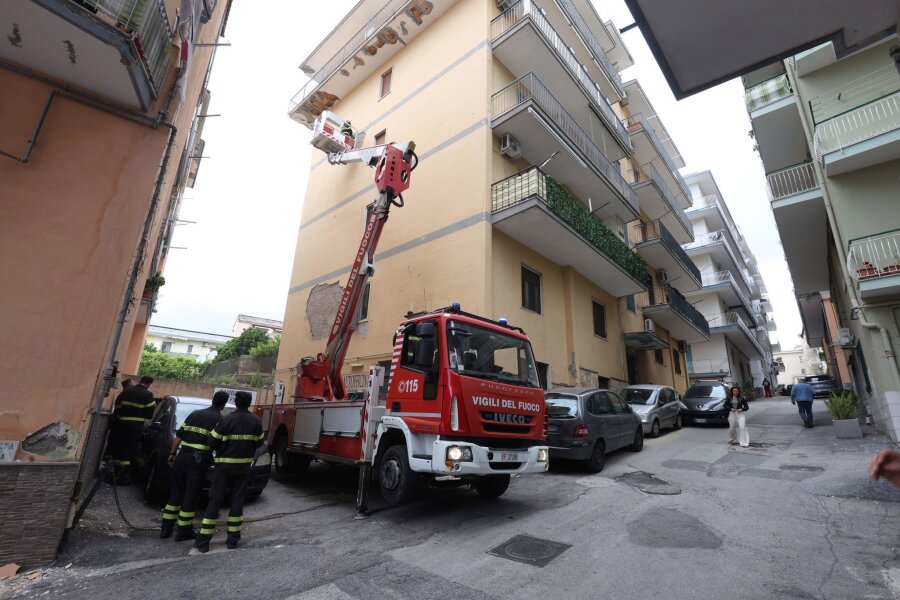 Erdbeben in Neapel: Häuser und Gefängnis evakuiert - Von einem Hubwagen aus inspiziert ein Feuerwehrmann Schäden an einem Gebäude.