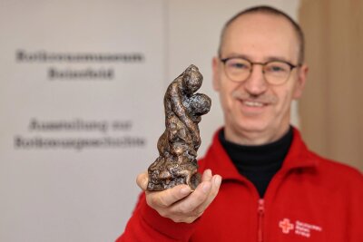 Erstmals vom DRK ausgereichter Preis für Geschichtsforschung geht nach Beierfeld - André Uebe zeigt den erstmals ausgereichten Castiglione-Preis des DRK. Eine gegossene Bronzeskulptur, die eine Frau zeigt, die einen Kranken stützt.