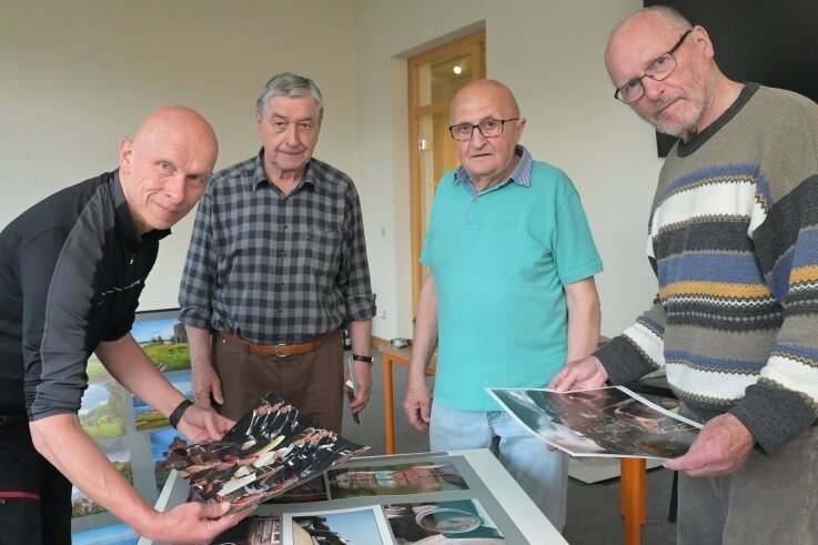 Bert Harzer, Joachim Ebert, Wilfried Weiß und Dr. Jürgen Brunner vom Fotoclub Oelsnitz (v. l.) beim Aufbau der Ausstellung in der Oelsnitzer Stadtbibliothek. 