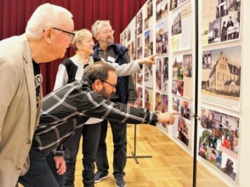 Fotos aus dem Leben in drei Orten wecken viele Erinnerungen - Wolfgang Lohr (v. l.), Klaus Schubert, Brigitte Lohr und Cheforganisator Jürgen Reuther beim regen Gedankenaustausch im Volkshaus. 