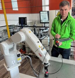 Für Azubis wird jetzt auch der Roboter zum Kollegen - Ausbilder Thomas Unger erklärte den Gästen im neuen Fachbereich die Funktionsweise und Einsatzmöglichkeiten des Knickarmroboters. Monotone Handgriffe wie das Bewegen von Teilen übernimmt nun Kollege Roboter.