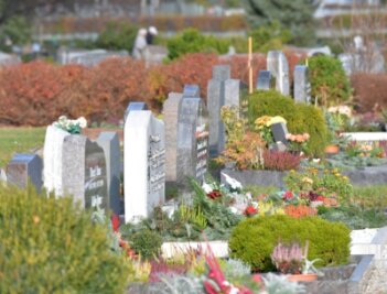 Grablichter als Zeichen des Gedenkens - Auf dem Freiberger Zentralfriedhof sind bereits viele Gräber winterlich bepflanzt und geschmückt. 