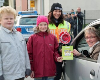 Grundschüler blitzen Verkehrsteilnehmer in Pockau - Alexander Nebe, Hanna Schönherr und Polizeiobermeisterin Doreen Jarsky überreichen Annett Börner ein kleines Dankeschön für umsichtiges Fahren.