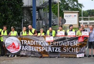 IG Metall kündigt Zukunftstarifvertrag mit Zugbauer Alstom - Alstom-Beschäftigte bilden vor dem Werkstor eine Menschenkette.