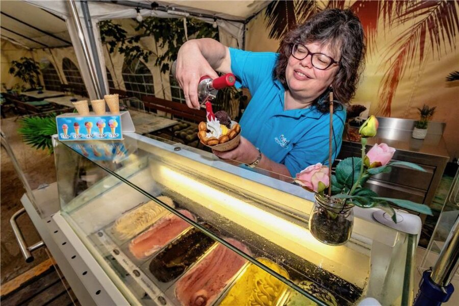 In der alten Zuckerbäckerei in Burgstädt wird jetzt wieder Eis verkauft - Chefin Jana Kiehl befüllt eine Bubble-Waffel im Biergarten ihrer Gaststätte „Zur alten Bäckerei" mit Vanille- und Schoko-Eis samt Sahne. Das italienische Eis gibt es in verschiedenen Geschmacksrichtungen, etwa Schoko-Chili-Orange, Erdbeer, Mango und Haselnuss.