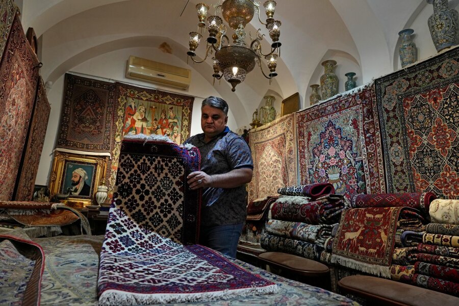 Iran will Arbeitswoche umstellen - Beginn am Sonntag - Ein iranischer Teppichhändler arbeitet in seinem Geschäft auf dem traditionellen Basar der Stadt Kashan.