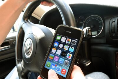Kontrolle durch die Polizeidirektion Zwickau: 19 Kraftfahrer mit Handy erwischt - Ein Autofahrer hat eine Hand am Smartphone. Das kommt offenbar immer noch relativ oft vor.