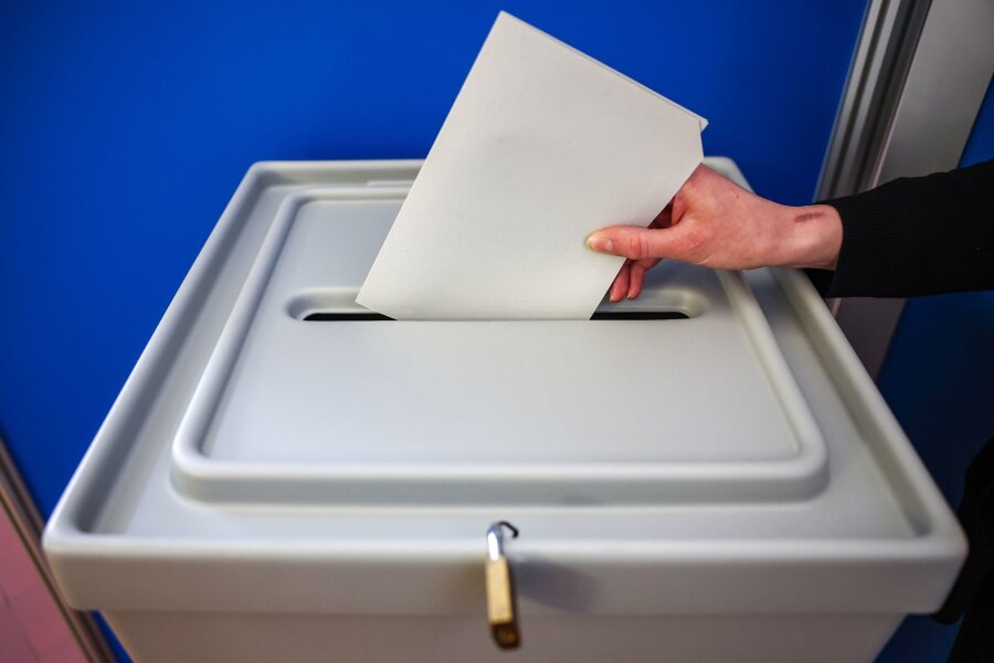 Landratsamt: Ortschaftsratswahlen in Reichstädt ungültig - Eine Frau wirft einen Stimmzettel in eine Wahlurne.