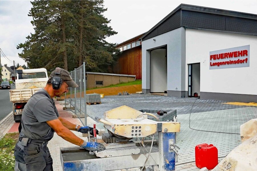 Heiko Hölzel von der Langenreinsdorfer Firma SWT schneidet Pflastersteine für die Außenanlagen des neuen Feuerwehrgerätehauses in dem Crimmitschauer Ortsteil zurecht. 