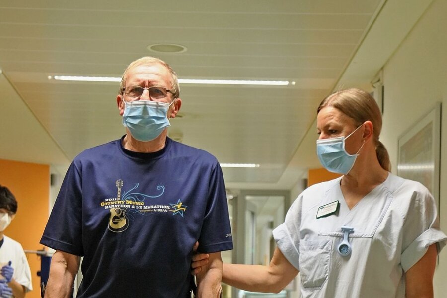 Marathon-Senior erhält neu entwickelte Knöchelschraube - Zwei Tage nach der Operation läuft Karl-Jürgen Riedel, geführt von Physiotherapeutin Ina Dankhoff, schon wieder durch den Gang der Station.