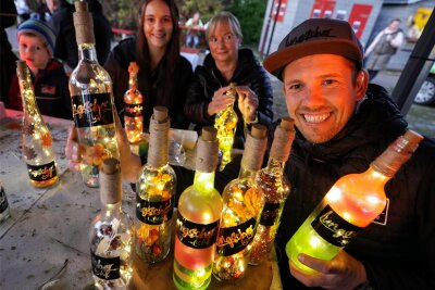Oberlungwitzer lassen es beim Herbstmarkt leuchten – Festmarathon geht weiter - Veranstaltungsmanager Ronald Haß zeigt den Renner beim Herbstmarkt: Weinflaschen, die dank Lichtern von innen leuchten.