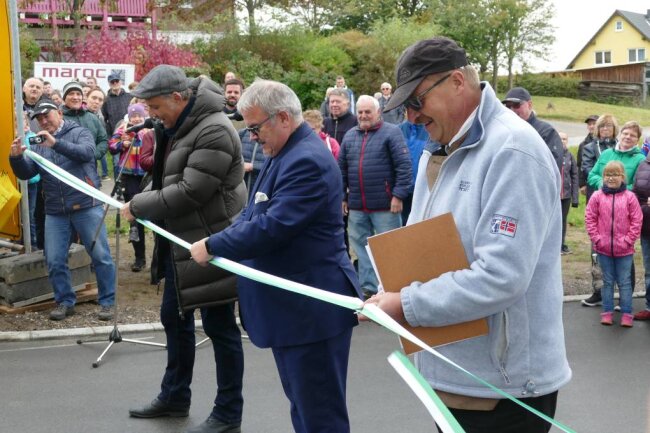 Ortsvorsteher Jörg Reichel, Landrat Frank Vogel und Zschopaus Oberbürgermeister Arne Sigmund (von rechts) gaben mit dem Zerschneiden des Bandes die Straße frei. 