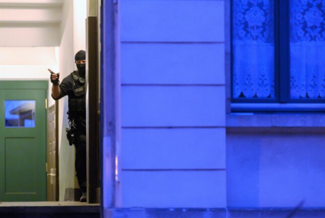 Dresden: Ein Polizist steht während einer Razzia in einem Haus im Stadtteil Pieschen.