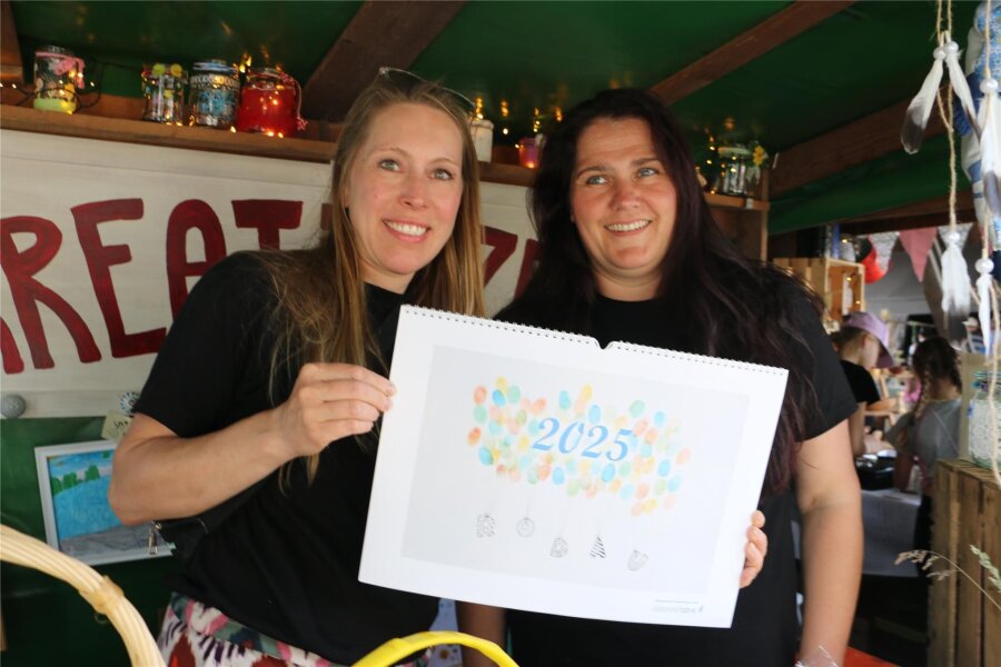 Rodauer Kinder kreieren Kalender für 2025 - Christina Michel (links) und Ivonne Prager zeigen den Kalender für 2025.