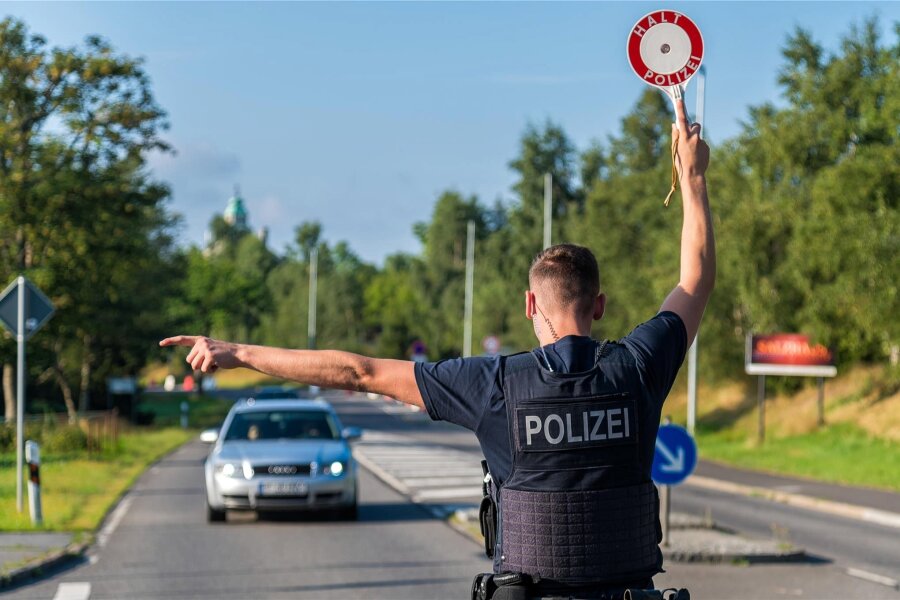 Schuhsohlen fotografieren und Handy auslesen: Was die Bundespolizei entlang der B 174 im Erzgebirge erlebt - Ein Polizist der Bundespolizeiinspektion Chemnitz stoppt in Reitzenhain einen in Rumänien zugelassenen Pkw.
