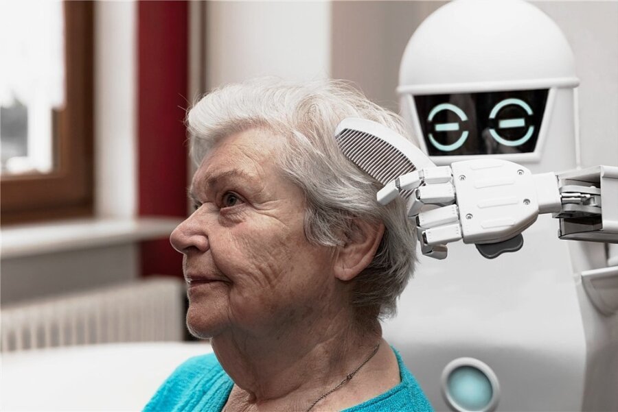 Sind Roboter bald die besseren Pfleger? - Sieht so die Zukunft aus? Ein Pflegeroboter kämmt einer Seniorin die Haare. Der Einsatz solcher digitalen Assistenzsysteme in der Pflege ist umstritten. 