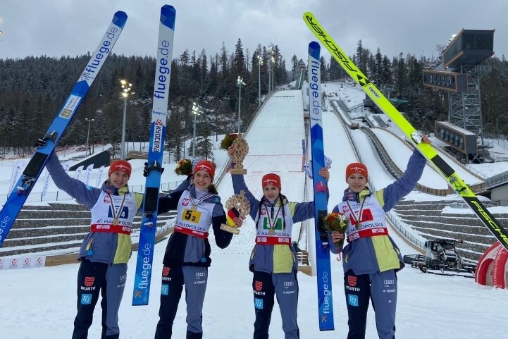 Lilly Kübler (2. von links) freut sich mit ihren Teamkameradinnen über Bronze im Mannschaftswettbewerb der Skispringerinnen. 