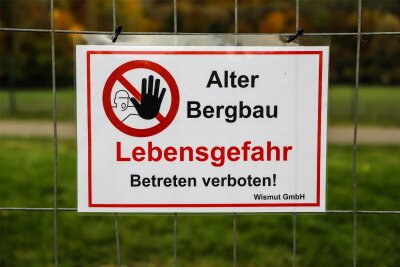 Tagesbruch-Gefahr im Erzgebirge: Kurpark in Bad Schlema teilweise gesperrt - Mit diesem Schild wird auf die mögliche Gefahr im Kurpark in Bad Schlema hingewiesen.