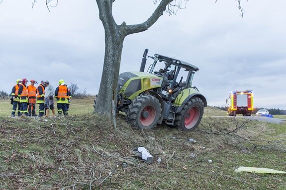 Traktor prallt frontal gegen Baum: Traktorfahrer verletzt, Baum gefällt - 