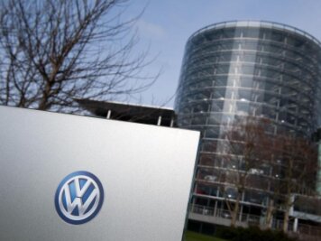 VW: Roboter überwachen Produktion -             Ein Volkswagen (VW) Logo an einem Schild der Volkswagen Gläserne Manufaktur.