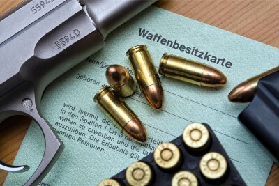Wie kann das Waffenrecht verschärft werden? - Eine Kaliber 9 mm Pistole, Patronen und ein Magazin liegen auf einer Waffenbesitzkarte:  Behörden haben mehr Rechtsextremisten mit Waffen auf dem Schirm.