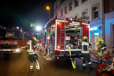 Wohnungsbrand in Chemnitz Hilbersdorf - Einsatzkräfte der Feuerwehr vor der brennenden Wohnung in der Frankenberger Straße in Chemnitz.