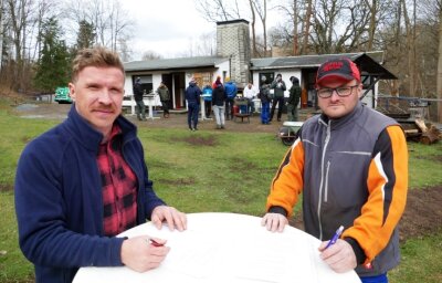 Zwei Vereine bündeln an Zschopaus Skihang ihre Kräfte - Für die Skibaude (hinten) haben Toni Fabian (links), der Vorsitzende des Shred-Erz-Vereins, und Patrick Frohs vom SV Nordisch/Alpine Zschopau einen gemeinsamen Pachtvertrag unterschrieben. 