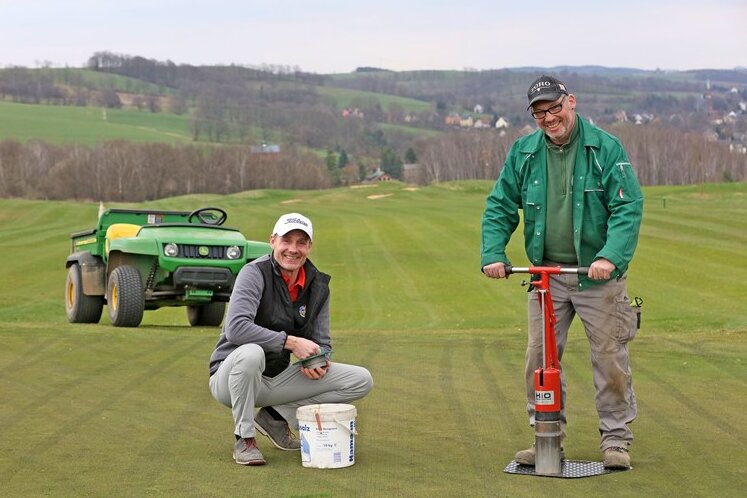 Zwickau: Golf-Saison beginnt am Freitag - Golfdirektor Roland Meyer (links) und Gerhard Schleicher, Greenkeeper des Golfplatzes, beim Setzen eines neuen Lochs auf dem Grün.