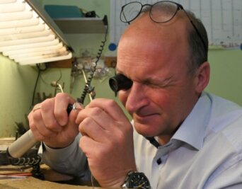 Zwickau ist schmuck und Schmuck - Andreas Lindner, Inhaber von "Juwelier Uhlmann", nimmt das neueste Stück aus der Zwickau-Kollektion unter dieLupe. Er hat es fertigen lassen, weil er seine Stadt gern mag. 
